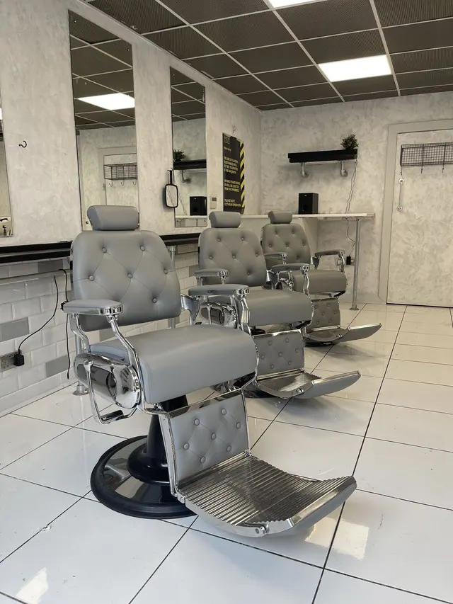Inside: grey barber chairs along the mirrors