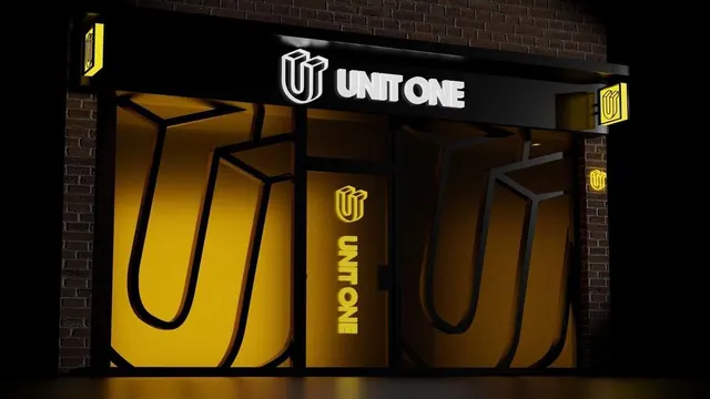 The Unit One sign at night